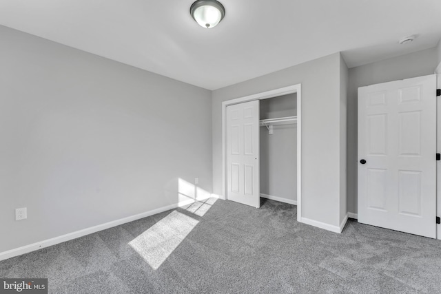 unfurnished bedroom with a closet and carpet