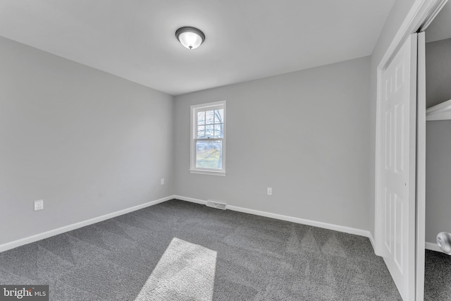 unfurnished bedroom featuring carpet flooring and a closet