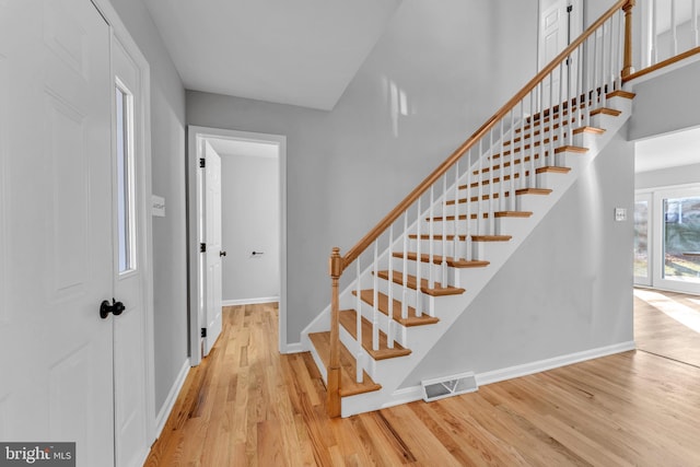 stairway with hardwood / wood-style flooring