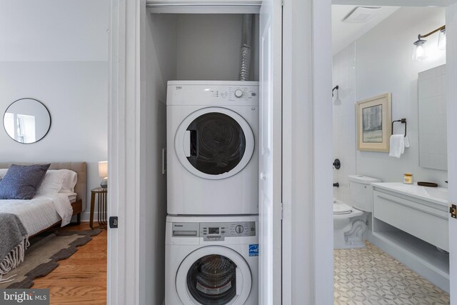 laundry area featuring stacked washer and dryer