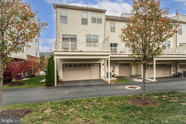 view of property with a garage and a balcony