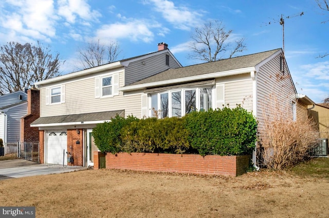 back of property with a garage, a yard, and central AC unit