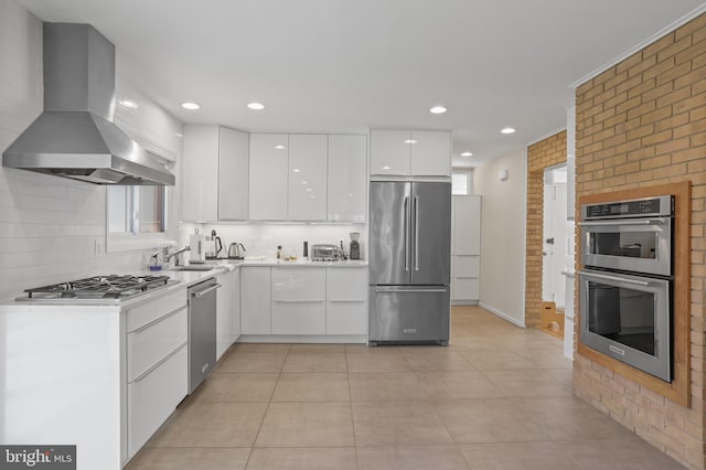 kitchen with stainless steel appliances, white cabinetry, light countertops, range hood, and modern cabinets