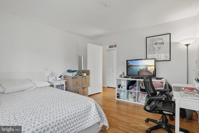 bedroom with visible vents and wood finished floors