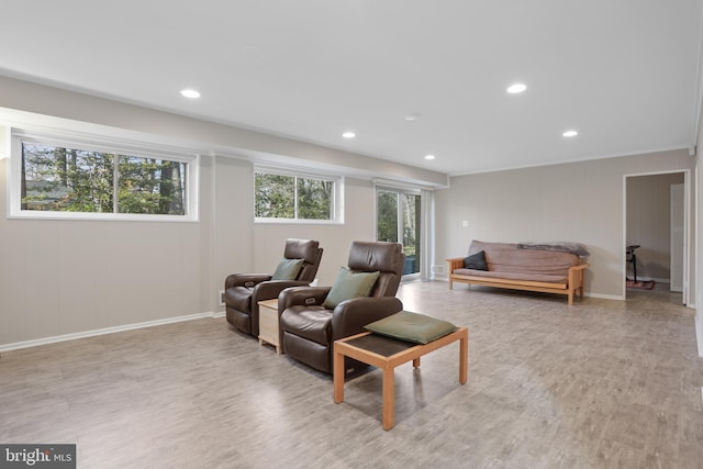 living area with light wood-type flooring, baseboards, and recessed lighting