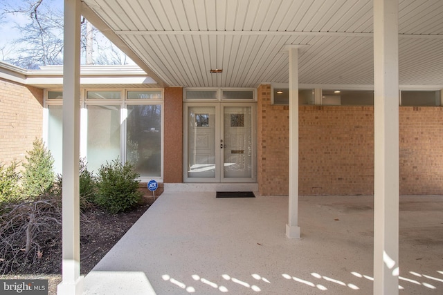 entrance to property featuring brick siding