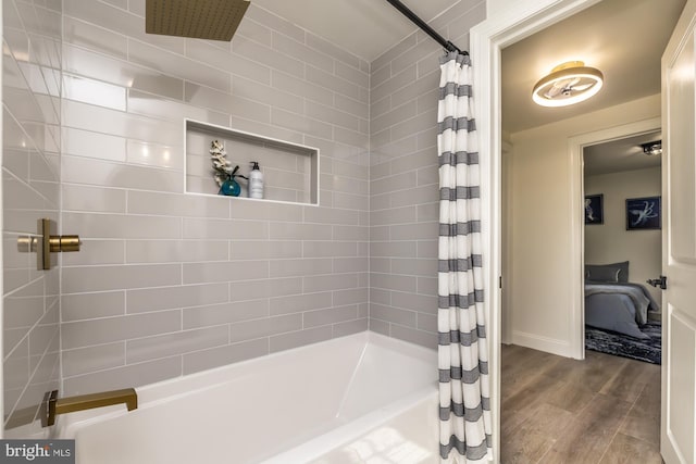 bathroom with shower / tub combo with curtain and hardwood / wood-style flooring