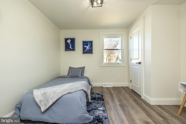 bedroom with hardwood / wood-style floors