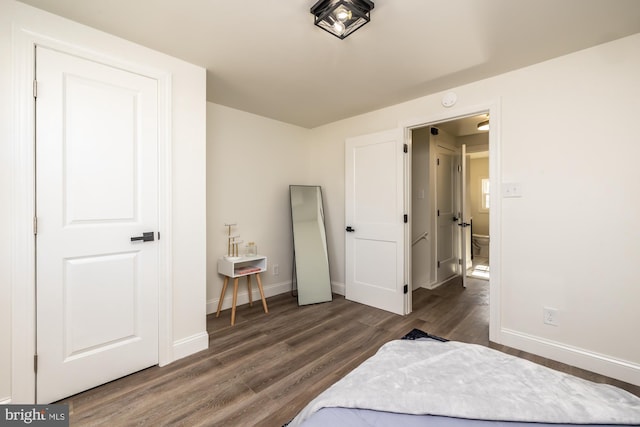 bedroom with dark hardwood / wood-style flooring