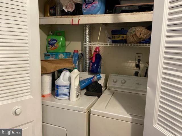 clothes washing area with washing machine and clothes dryer