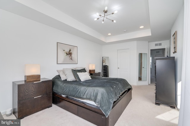 bedroom featuring light carpet, a closet, a raised ceiling, and a chandelier