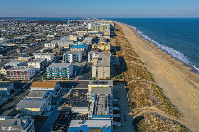 birds eye view of property featuring a water view and a view of the beach