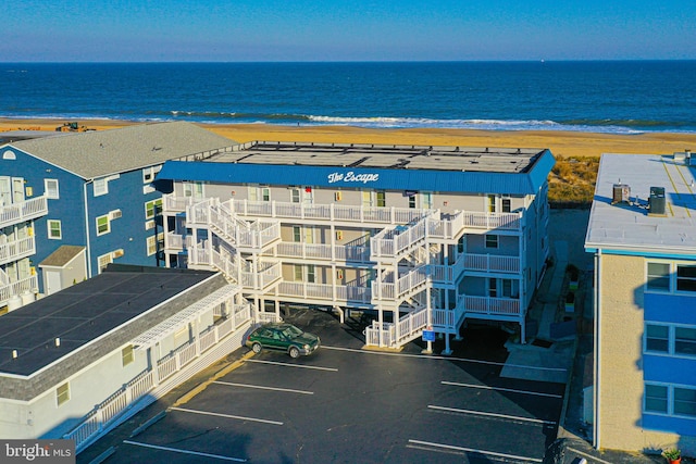 bird's eye view with a water view and a beach view