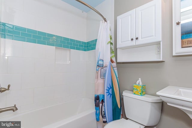 bathroom with shower / tub combo and toilet