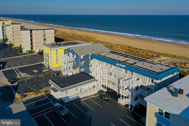 drone / aerial view featuring a beach view and a water view