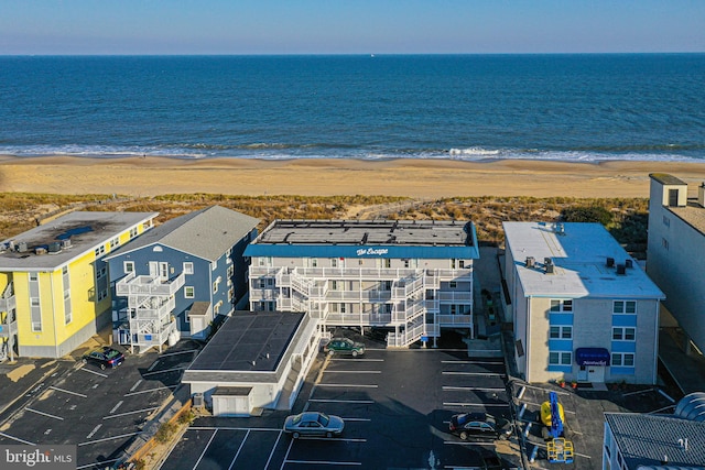 birds eye view of property with a beach view and a water view