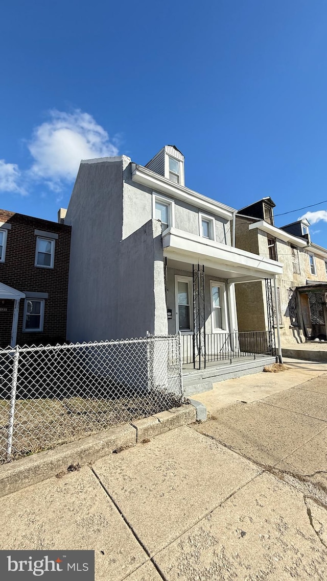 townhome / multi-family property featuring a porch