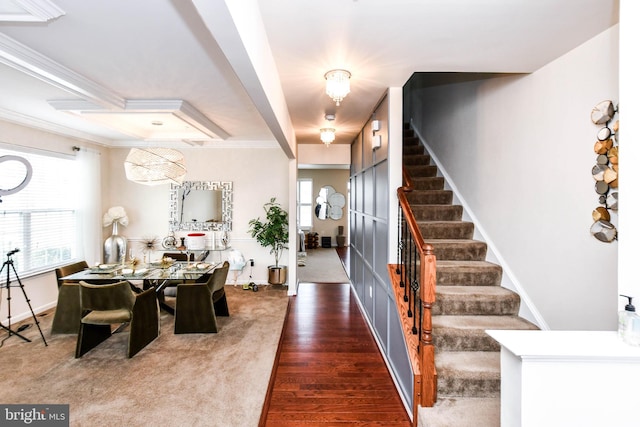 dining area featuring crown molding, dark wood finished floors, stairway, and baseboards