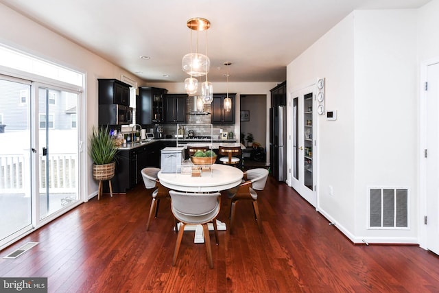 dining room featuring dark wood-type flooring and visible vents