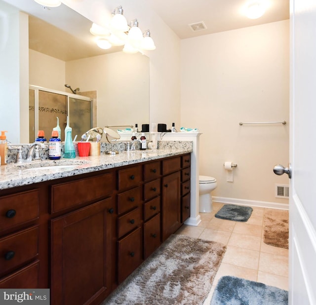 full bathroom featuring double vanity, visible vents, a sink, and tile patterned floors