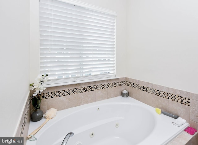 bathroom featuring a tub with jets