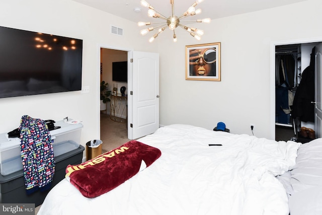 bedroom with visible vents and a notable chandelier