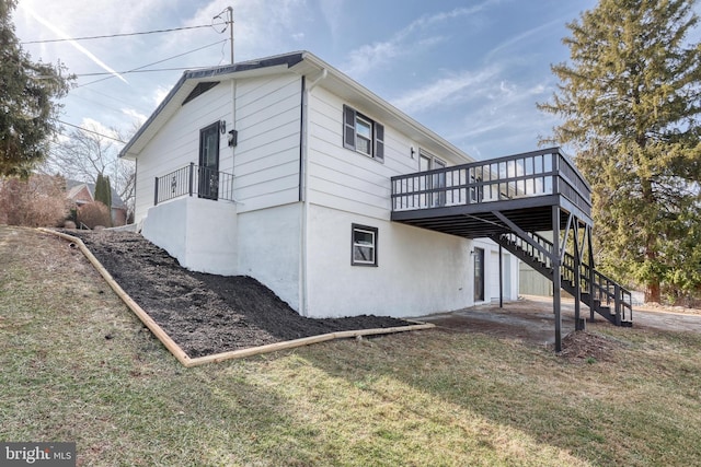 view of home's exterior with a yard and a deck