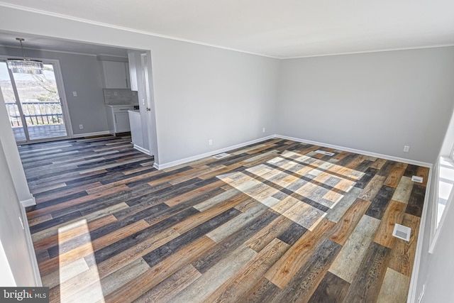 spare room featuring crown molding and dark hardwood / wood-style floors