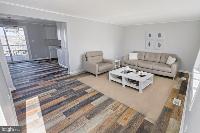 living room featuring crown molding and dark hardwood / wood-style flooring