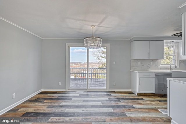 kitchen with an inviting chandelier, stainless steel dishwasher, light wood-type flooring, and white cabinets