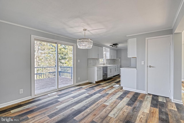 kitchen with dishwasher, white cabinets, dark hardwood / wood-style flooring, decorative backsplash, and hanging light fixtures