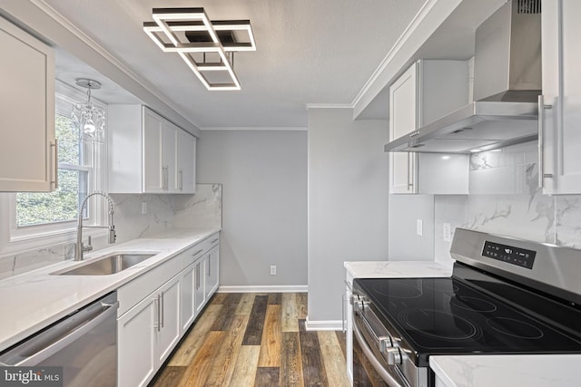 kitchen featuring white cabinetry, stainless steel appliances, sink, and wall chimney range hood