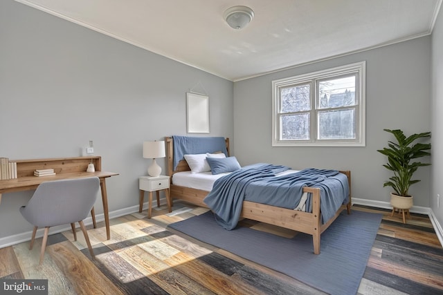 bedroom featuring crown molding and hardwood / wood-style flooring