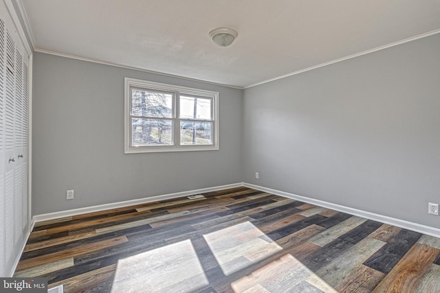 unfurnished room featuring crown molding and dark hardwood / wood-style floors