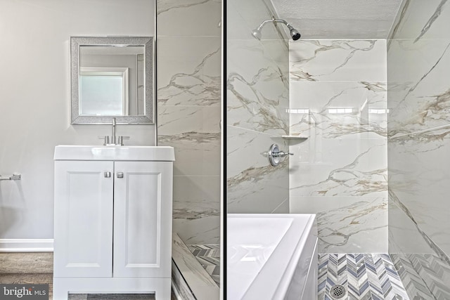 bathroom featuring vanity and tiled shower