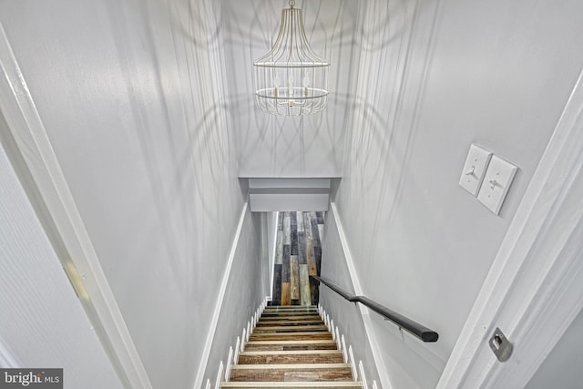 stairs featuring an inviting chandelier