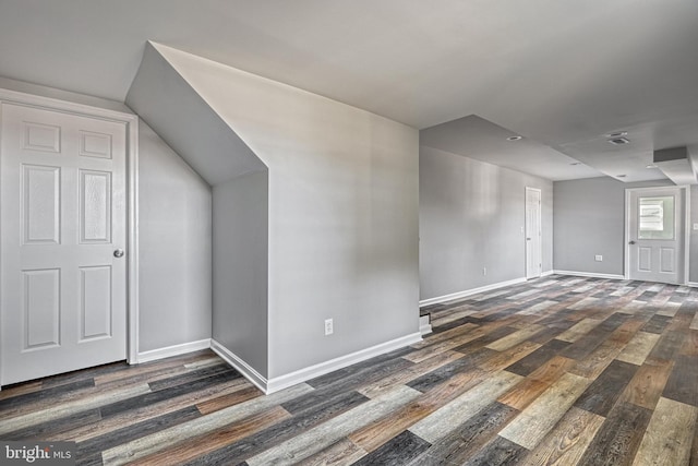 additional living space with dark wood-type flooring