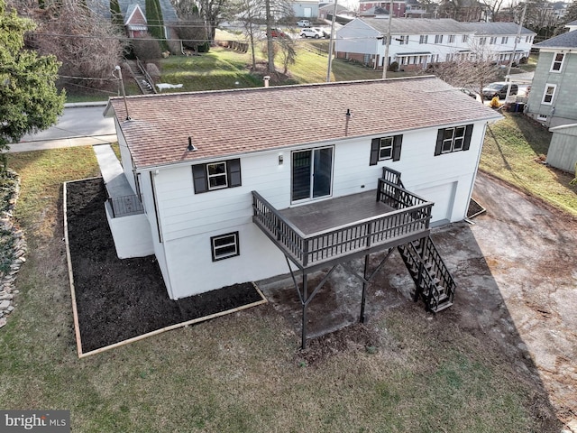 rear view of house featuring a wooden deck