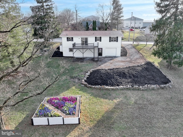 back of house featuring a yard and a garage