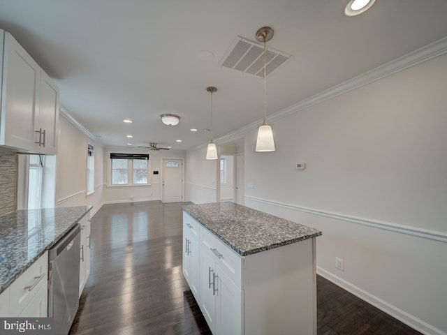 kitchen featuring dark hardwood / wood-style floors, decorative light fixtures, dark stone countertops, white cabinets, and stainless steel dishwasher