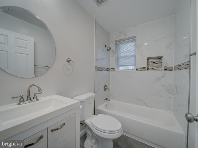 full bathroom with vanity, tiled shower / bath, and toilet