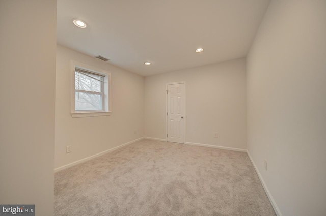 unfurnished room featuring light colored carpet