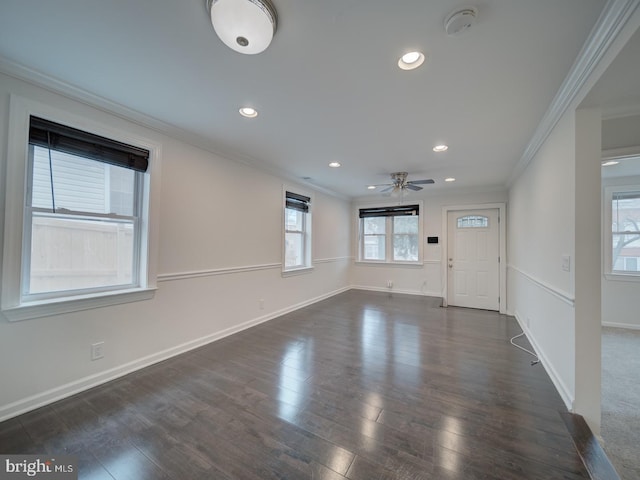 entrance foyer featuring dark wood-type flooring, ceiling fan, and crown molding