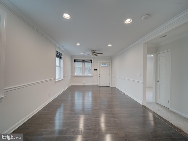 empty room with crown molding, ceiling fan, and dark hardwood / wood-style floors