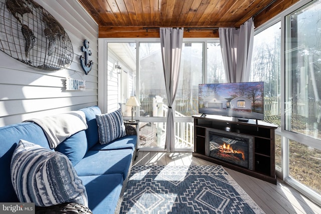 sunroom featuring wood ceiling and a wealth of natural light