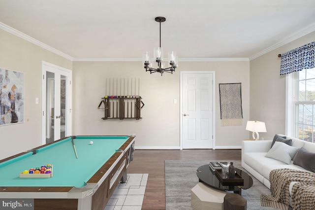 game room with crown molding, dark wood-type flooring, an inviting chandelier, pool table, and french doors