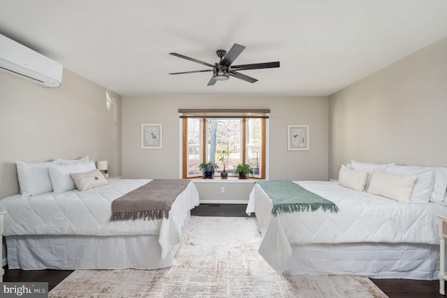 bedroom with ceiling fan, wood-type flooring, and an AC wall unit