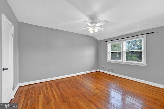 spare room with hardwood / wood-style flooring, ceiling fan, and lofted ceiling