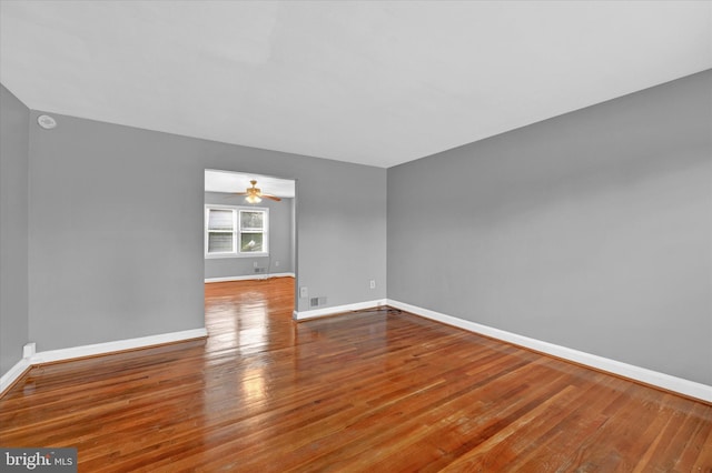 empty room featuring hardwood / wood-style floors and ceiling fan