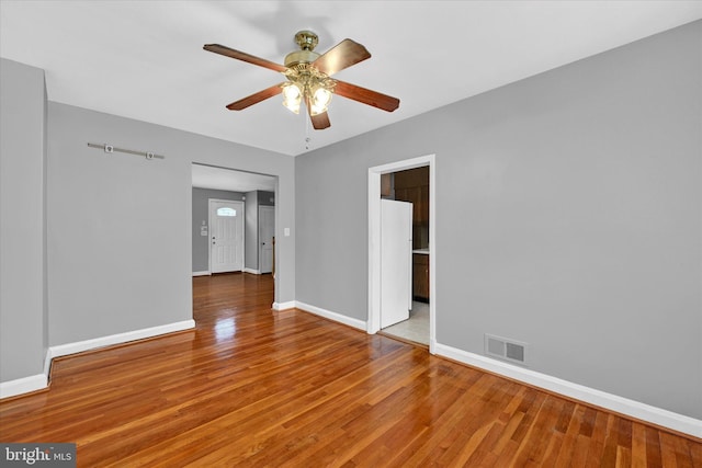 empty room with wood-type flooring and ceiling fan